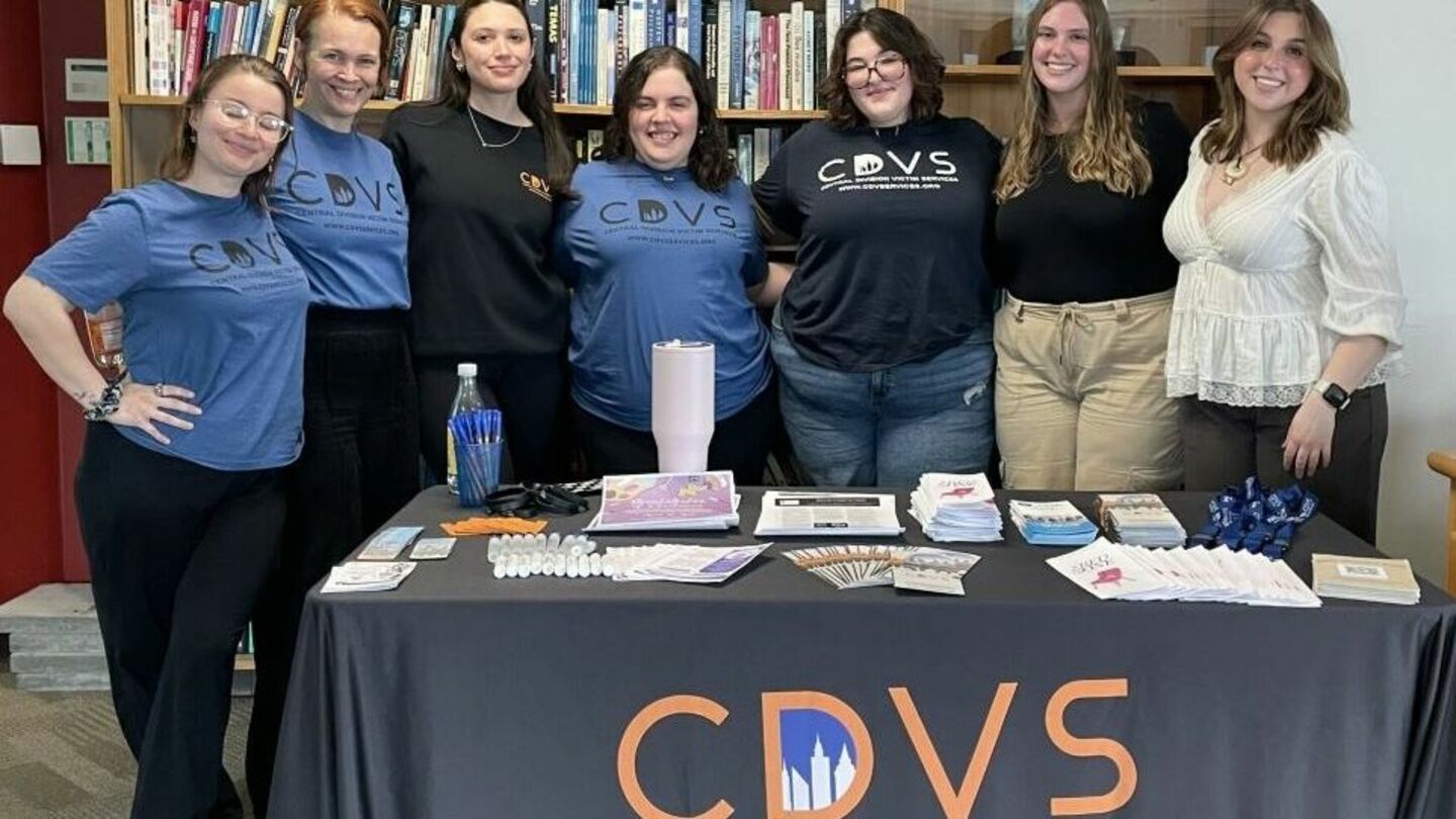 image of students standing in front of a table for a group shot