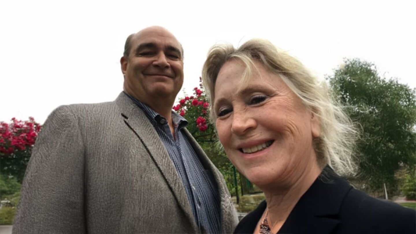 image of Patrick H. Tolan and his wife Virginia Evans standing in a garden smiling at the camera